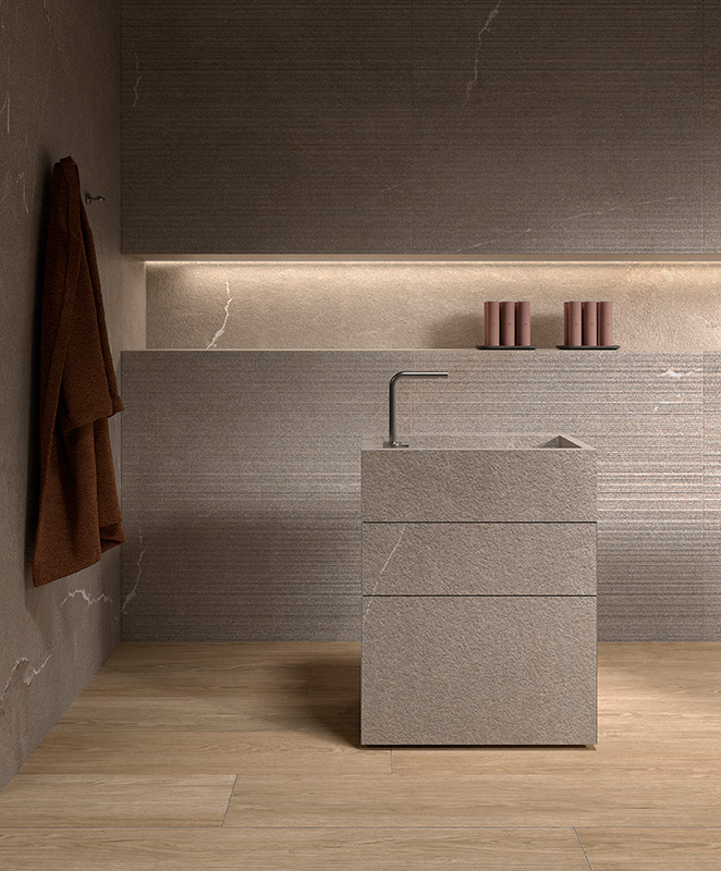 Freestanding stone basin unit with a tap, in a tiled room